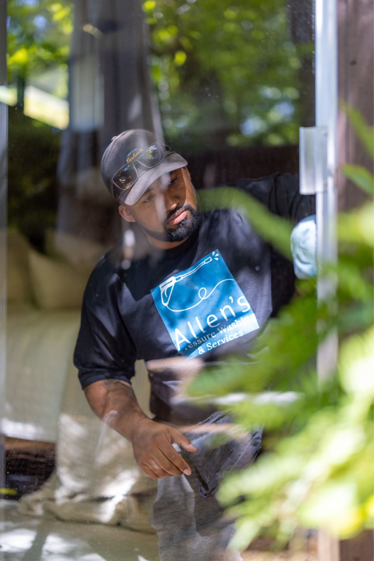 Levonte Allen cleaning a Yakima Valley window in summer light.